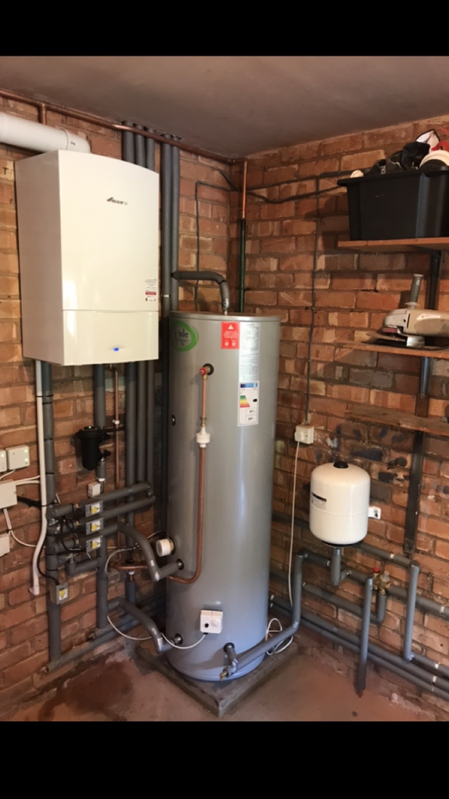 A Worcester system boiler and unvented hot water cylinder installed together in a brick outbuilding