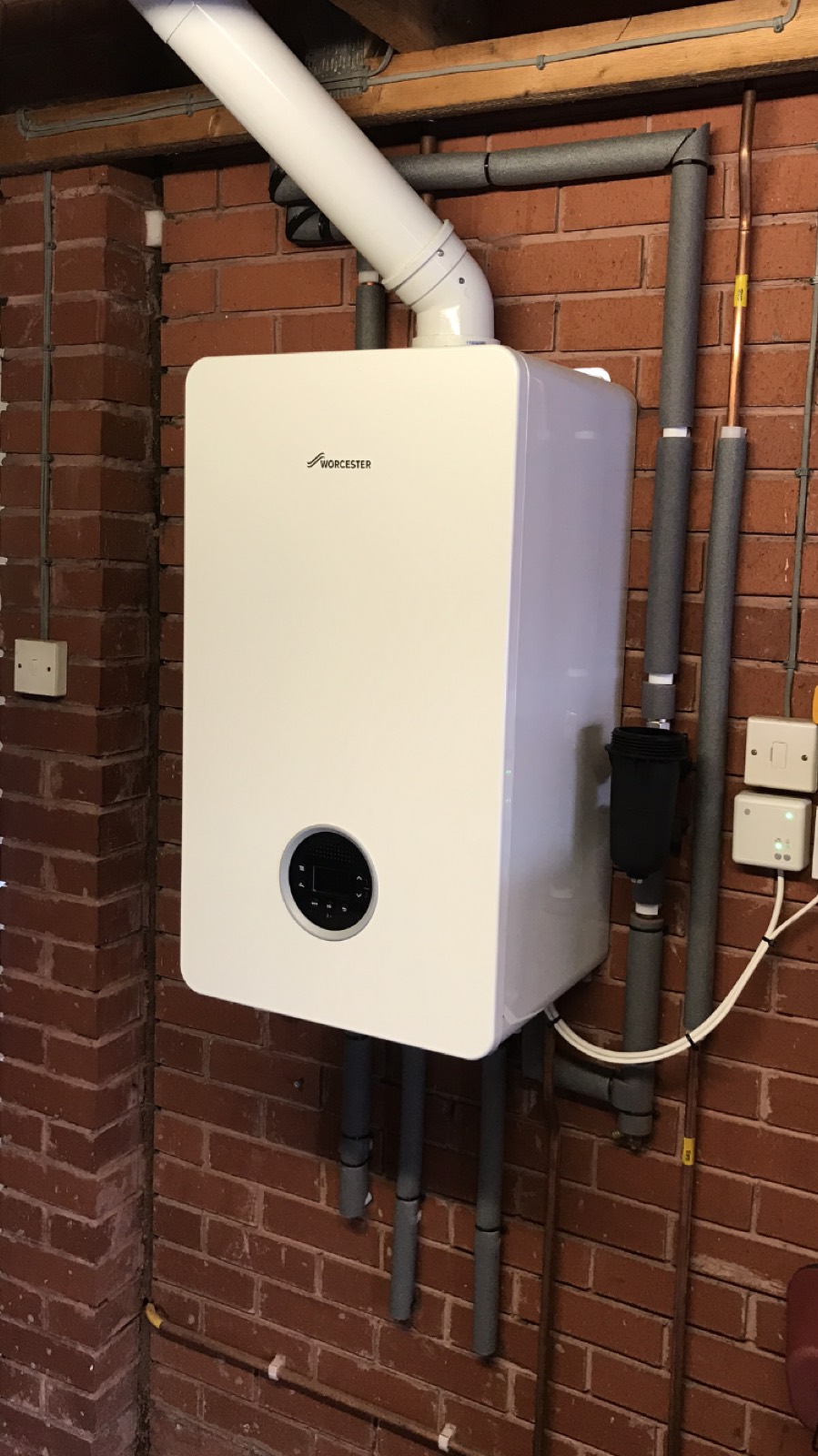 A Worcester Greenstar wall-hung boiler in a garage with the flue run out through the roof